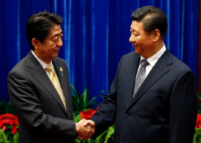 Japan's Prime Minister Shinzo Abe (L) shakes hands with China's President Xi Jinping (R), during their meeting at the Great Hall of the People, on the sidelines of the Asia Pacific Economic Cooperation (APEC) meetings, in Beijing, China, 10 November 2014. Jinping and Abe met for the first time for face to face talks, since they came into office. Photo: EPA/KIM KYUNG-HOON / POOL