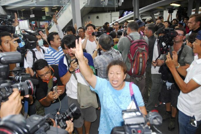 Anti-coup activist in Thailand flashes the three-finger salute in Bangkok on 1 June 2014.