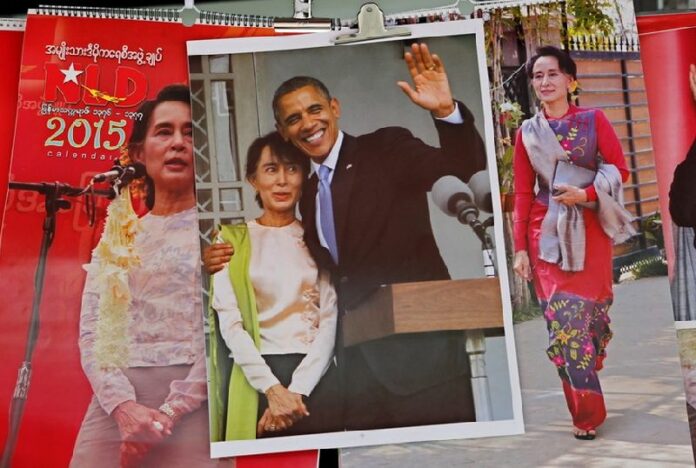 A poster with the image of US President Barack Obama and Myanmar opposition leader Aung San Suu Kyi (C) is seen in front of a souvenir shop of National League for Democracy (NLD) party headquarters in Yangon, Myanmar, 10 November 2014. Obama is to meet Suu Kyi in Yangon, amid a renewed debate over the pace of the country?s political reforms. EPA/LYNN BO BO