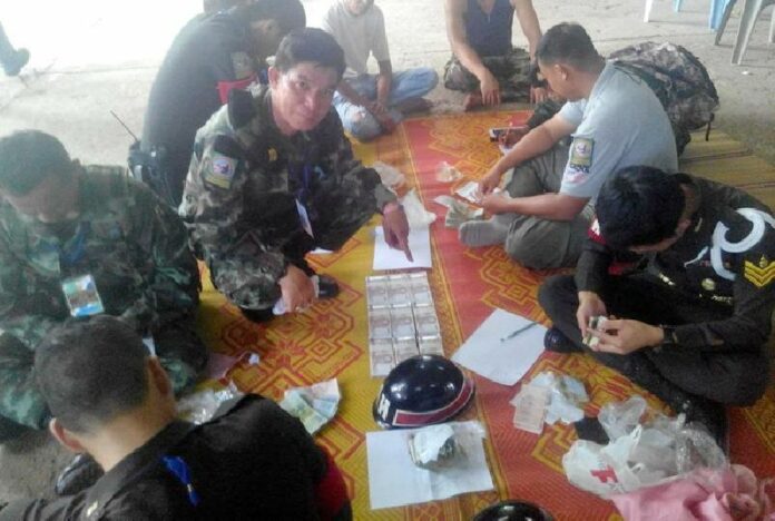 Soldiers confiscated nearly one million baht in cash and several firearms during a surprise raid on a Buddhist temple in Sukhotai province, 26 Sept 2014.