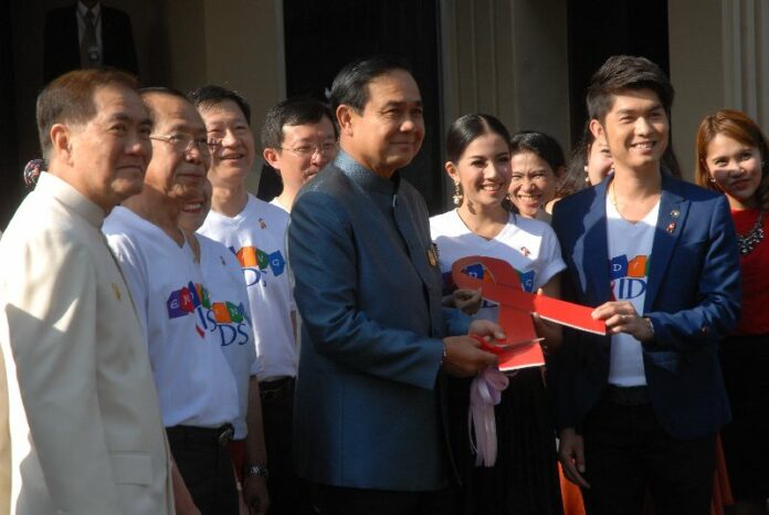 Gen. Prayuth Chan-ocha, chairman of the military junta and Prime Minister, poses for photo in a campaign to promote HIV-AIDS awareness in Thailand before he attends Cabinet meeting at Government House, 25 November 2014