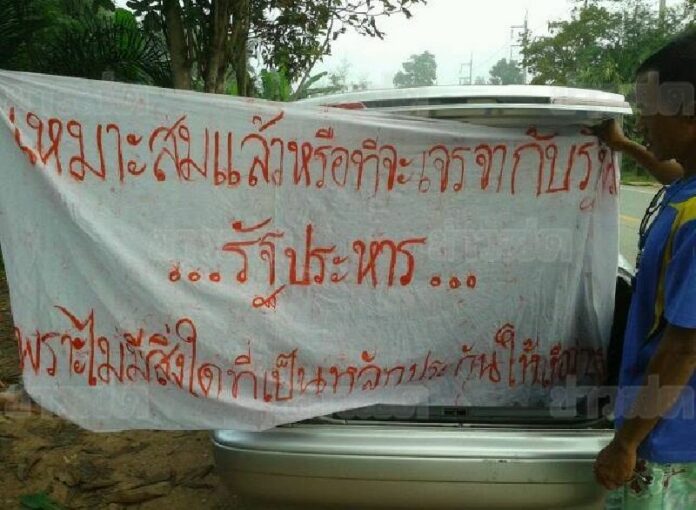 The banners, written in Thai, English, and Malay, read: "Is it appropriate to negotiate with the coup government? There is no guarantee for sincerity."<br />