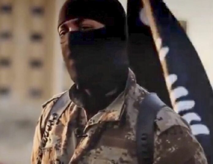 A screen shot from a video released by the Federal Bureau of Investigation on 07 October 2014 shows an alleged Islamic State militant claiming to be inside the Syrian 17th Division Military Base just outside Al-Raqqah, Syria. Police have identified a Malaysian Islamic State jihadist who carried out a suicide attack on a Syrian government military base. EPA/FEDERAL BUREAU OF INVESTIGATION <br />