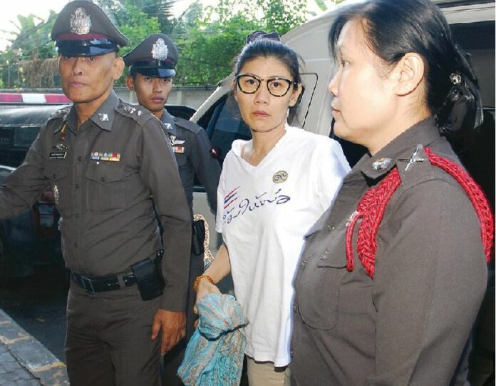 Sudathip Muangnuan en route to the Criminal Court in Bangkok on 11 Dec 2014, a day after she was arrested on charges of lese majeste.<br />