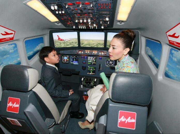 Former Princess Srirasmi and her son Prince Dipangkorn Rasmijoti visit the Air Asia headquarters in Bangkok on 6 May 2013.<br />