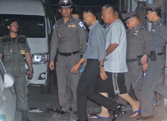 Pol.Lt.Gen. Pongpat Chayapan (in white) being taken to court, where he was denied bail, 24 November 2014