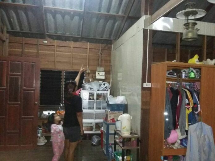 Nanthawan Yotsunthorn pointed to where the bullet struck the roof of her house, 29 December 2014