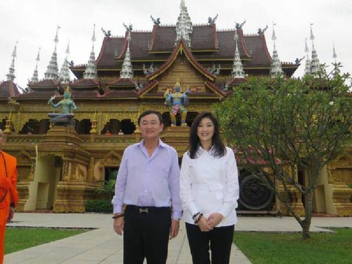 Former Prime Ministers Thaksin and Yingluck Shinawatra in southern China in November 2014.<br />