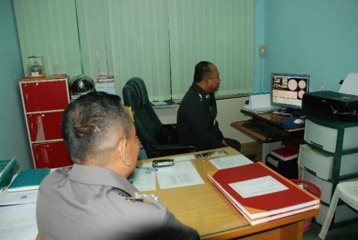 Pol.Col. Samart consults provides an astrological reading in his office in Pitsanulok province, 13 Jan 2015.<br />