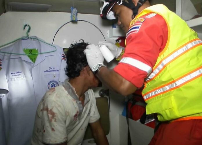 Rescue workers come to the aid of a man injured in a brawl at a karaoke bar in Chonburi province on 21 Jan 2015.
