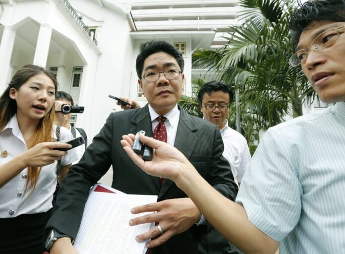 A file photo shows the Thai lawyer of a Japanese father involved in a surrogacy scandal, Kong Suriyamonthon (C), talking to the media after a meeting with police officers at the Royal Thai Police headquarters in Bangkok, Thailand, 09 September 2014. A Japanese man, Shigeta Mitsutoki, has successfully sued the Thai government for paternal rights for three of the 12 babies he had through surrogate mothers. EPA/NARONG SANGNAK