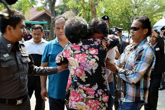 Ekkachai Ploihin, 28, gets a goodbye hug from his mother before soldiers bring him to Bangkok Remand Prison, 3 Feb 2015.