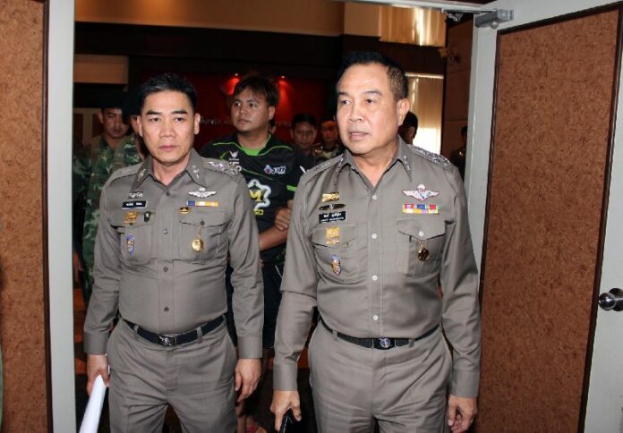 Krit Bootdeecheen (center) led by police at the Royal Thai Police HQ in Bangkok, 4 Feb 2015.<br />