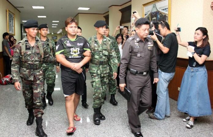 Krit Bootdeecheen, 25, is taken by soldiers for interrogation on 4 Feb 2015 in connection with a fake royal statement that was spread on social media.