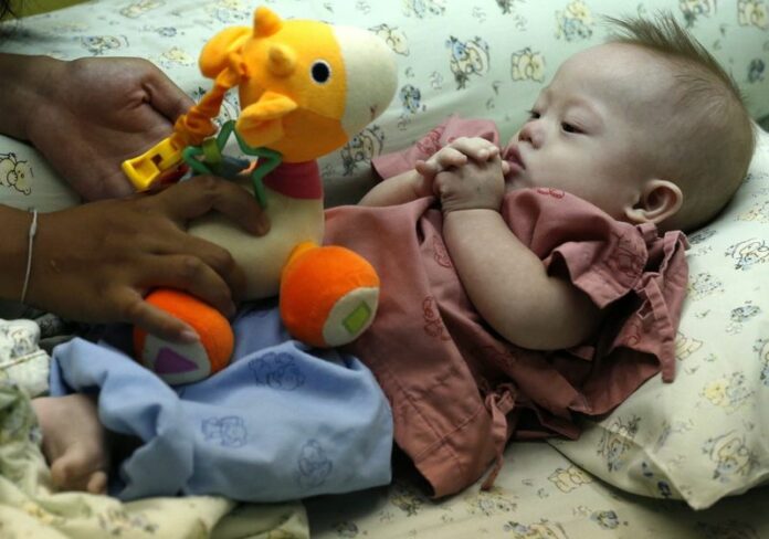 A file photo shows a surrogate baby with Down's Syndrome at a hospital in Chonburi province, Thailand, 04 August 2014. Thailand outlawed commercial surrogacy, after a scandal last year highlighted a blind spot in the country's legislation. EPA/RUNGROJ YONGRIT<br />