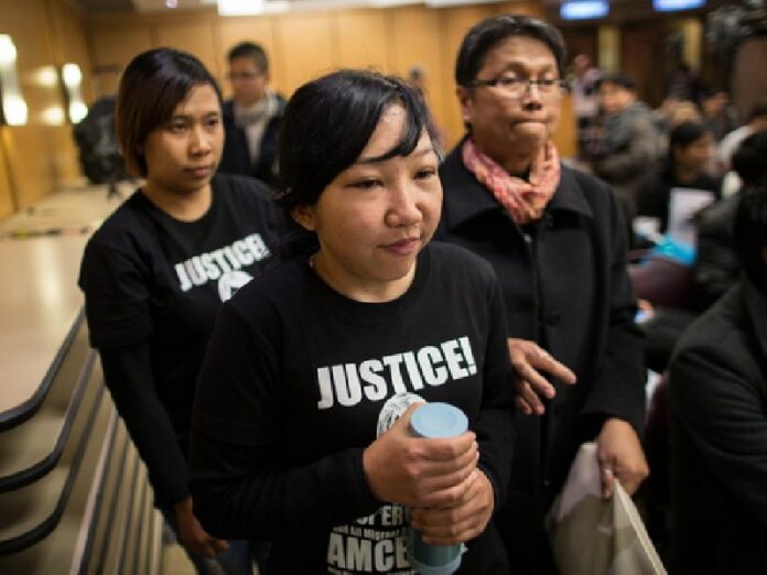 Former Indonesian maid Erwiana Sulistyaningsih (C) arrives at a press conference in Hong Kong, China, 10 February 2015. A woman has been sentenced to six years in prison for abusing her former Indonesian maids, in a case that drew international attention. EPA/JEROME FAVRE
