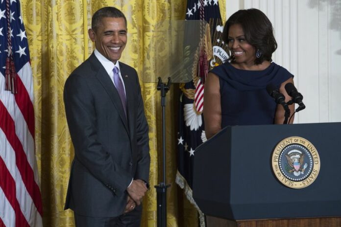 <br />First Lady Michelle Obama (R), with US President Barack Obama, delivers remarks on expanding efforts to help adolescent girls worldwide attend and stay in school, during an event in the East Room of the White House in Washington, DC, USA 03 March 2015. Obama will travel to Japan and Cambodia this month to promote girls' education around the world. EPA/SHAWN THEW