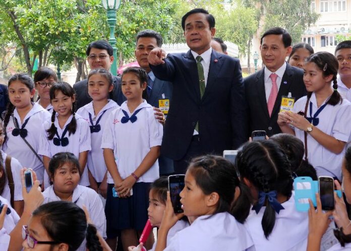 Gen. Prayuth Chan-ocha with schoolchildren at the Government House to promote his 12 Values, 20 March 2015.<br />