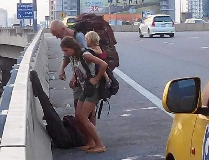 Photo posted by Facebook user Surachai Hiranpraditthakul that purported to show a foreign couple and toddler being forced to get out of a cab on the expressway because their taxi driver took a wrong turn.