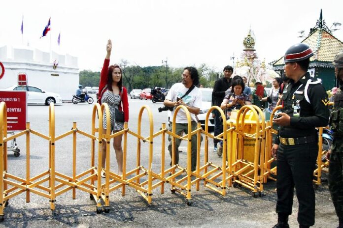 Student activist flashes an anti-coup salute in front of martial court in Bangkok on 26 March 2015.