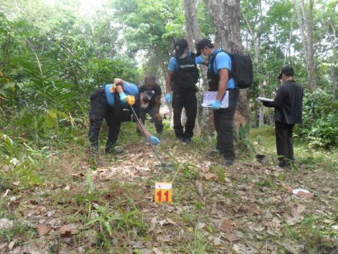Soldiers inspect the scene of the raid in To Chud village, Pattani, 26 March 2015.
