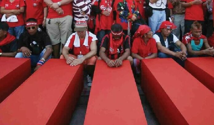 Redshirt protesters on 11 April 2010 with coffins of those killed in the crackdown on the previous day.<br />