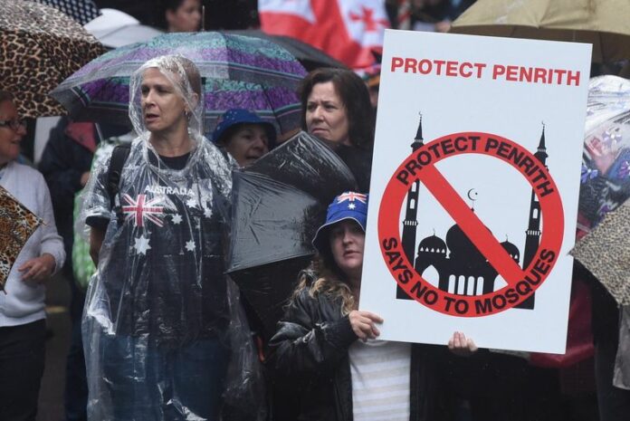 Protesters supporting the 'Reclaim Australia' group hold anti-Muslim placards during a protest rally in Sydney, Australia, 04 April 2015. EPA/MICK TSIKAS AUSTRALIA AND NEW ZEALAND OUT<br />