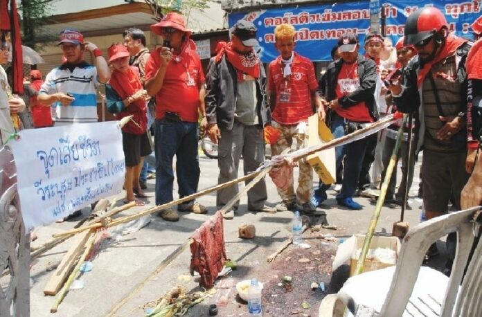 Redshirt protesters gather at the spot where a demonstrator was shot dead during the 10 April crackdown in Bangkok, 11 April 2010