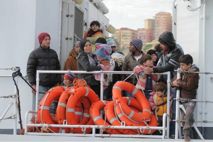 Rescued migrants disembark from an Italian Coast Guard vessel in Porto Empedocle. There were reports Sunday that a ship carrying 700 migrants capsized off the Libyan coast. EPA/PASQUALE CLAUDIO MONTANA LAMPO