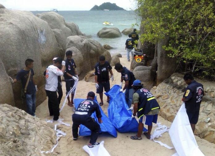 Thai rescue workers wrap the bodies of two British tourists who were found dead on a beach of Koh Tao island, Surat Thani province, southern Thailand. A Thai court has allowed independent verification of the DNA evidence against two suspects in the beach murder of two British holidaymakers last year. EPA/STR THAILAND OUT<br />