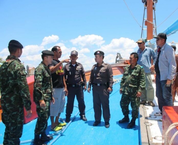 Security officers board a fishing boat in Prachuap Kiri Khan province to look for victims of human trafficking, 6 May 2015.