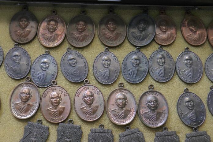 Amulets bearing faces of Luang Phor Koon at a market in Nakhon Ratchasima province, 16 May 2015