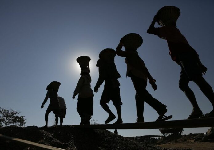 Myanmar workers carry baskets loaded with gravel on their shoulders as they pile up those near a jetty of Yangon River, Yangon, Myanmar, 27 January 2015. The international rush for lucrative investments in Myanmar is being slowed by looming elections. EPA/LYNN BO BO<br />