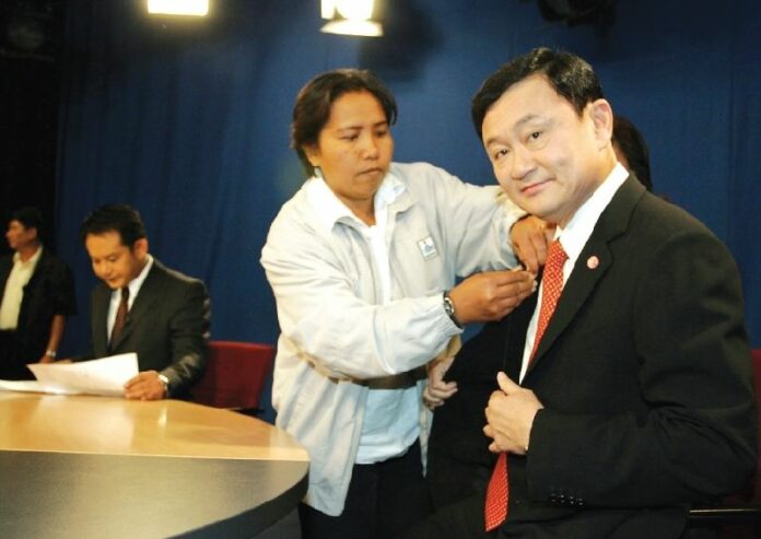 Then-Prime Minister Thaksin Shinawatra prepares for an interview at the state-owned Channel 11 TV station in Bangkok, 3 April 2006.