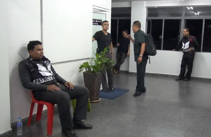 Police officers posted to keep guard in front of the room where Lt.Gen. Manas Kongpaen was being interrogated at Hat Yai Police Station, Songkhla, 3 June 2015<br />