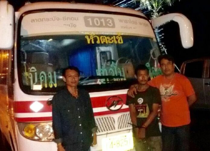 Sataanphop Aobpirom, 28, with police officers and the bus he allegedly stole in Bangkok, 15 June 2015.