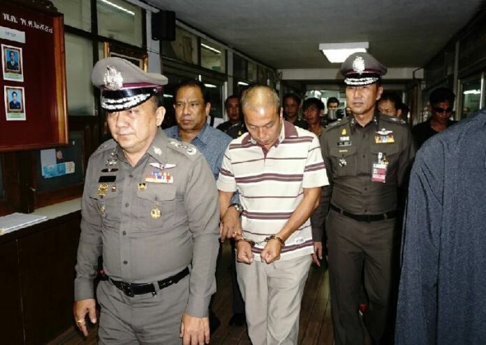 Police escort former royal aide Montri Sotangkul for a health inspection at Phahonyothin police station, 16 June 2015.