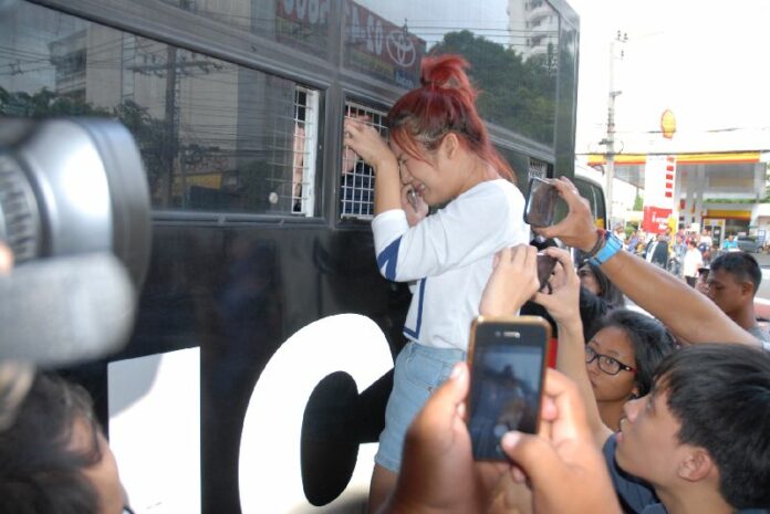 Police arrest student activists and take them away in police vans the day after they staged a pro-democracy march in Bangkok, 26 June 2015.<br />