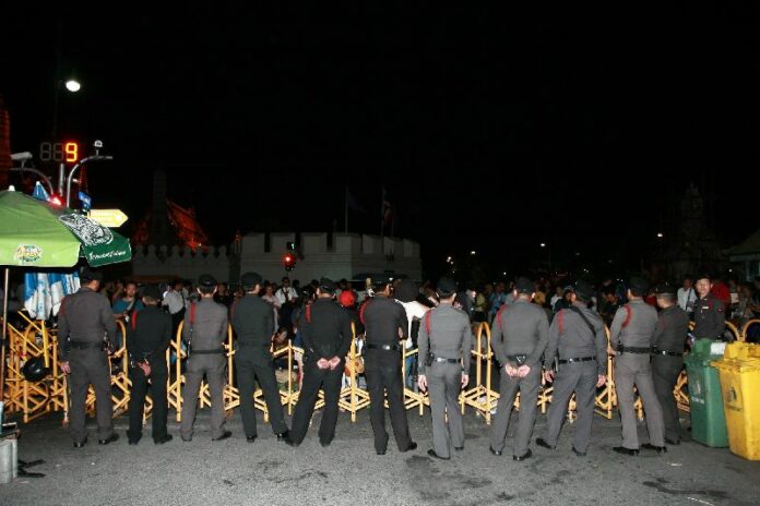 Police guard a martial court in Bangkok where dozens of people gathered to support 14 pro-democracy activists who were denied bail on 26 June 2015.