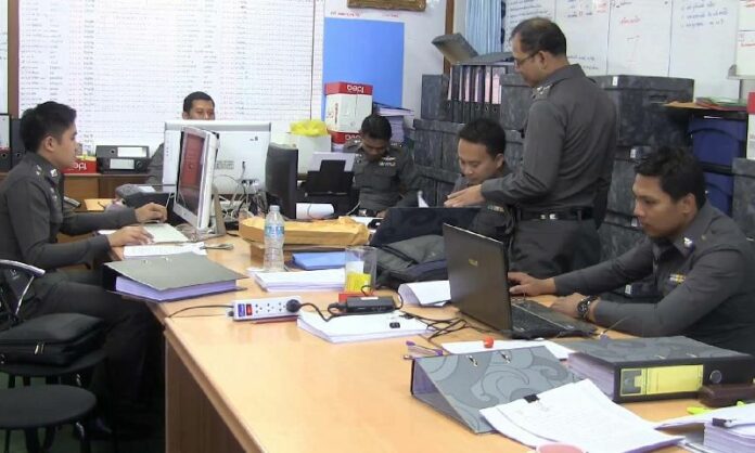Police officers processing the case files for suspected human traffickers in Songkhla province on 30 June.