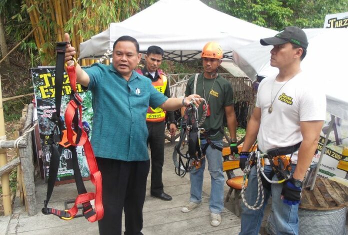 Chiang Mai Zoo staff check the equipment at a zipline company based in the zoo, 2 July 2015.