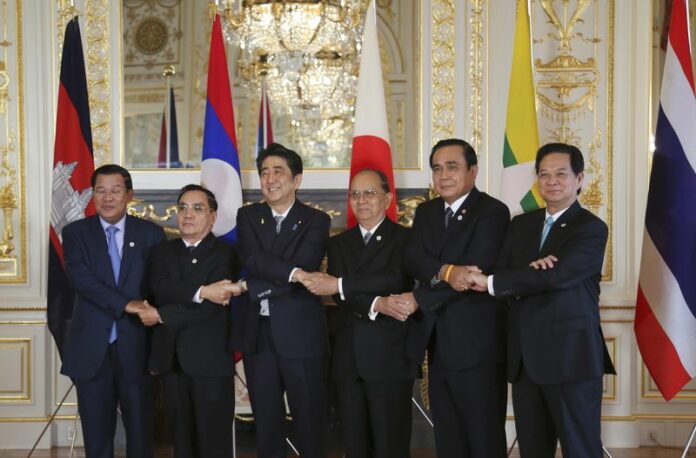 Leaders from rom Cambodia, Laos, Japan, Myanmar, Thailand, and Vietnam join hands for a group photo prior to the 7th Mekong-Japan Summit meeting at the Akasaka State Guest House in Tokyo, Japan, 04 July 2015. EPA/KOJI SASAHARA