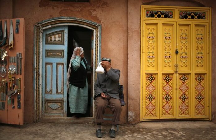 A Uighur man has tea while his wife looks on in the old town of Kashgar, Xinjiang Uighur Autonomous Region, China, 24 May 2013. EPA/HOW HWEE YOUNG