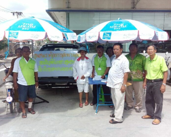 Local residents and officials gather signatures for a pedestrian safety petition across the street from where a woman was killed by an oncoming motorcycle in Pathum Thani, 15 July 2015.
