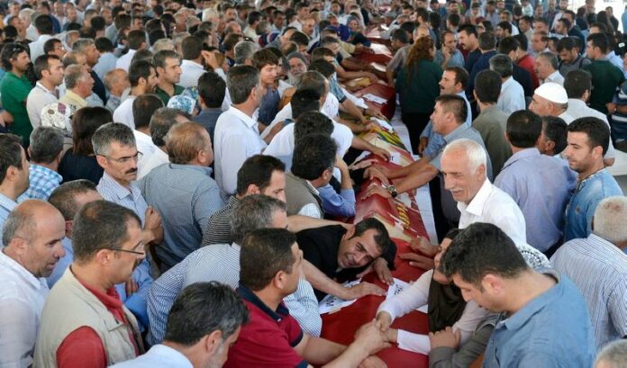 Friends and relatives of the victims of the bombing in Suruc, near the border between Turkey and Syria, mourn at the funerals of 16 of those killed, in Gaziantep, Turkey. EPA/DENIZ TOPRAK