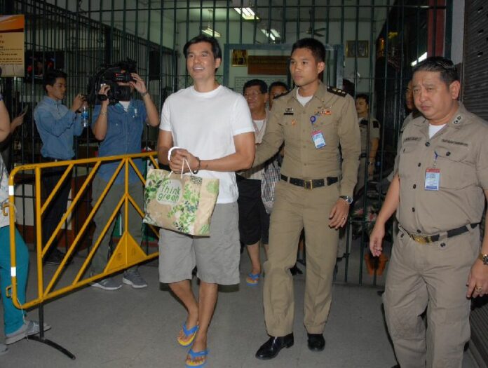 Pheu Thai’s spokesperson, Prompong Nopparit, being taken from Supreme Court to prison on 24 July 2015.