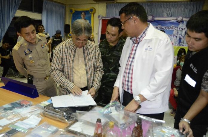 Officials and soldiers inspect evidence confiscated from two brothels in Nong Khai, 28 July 2015.