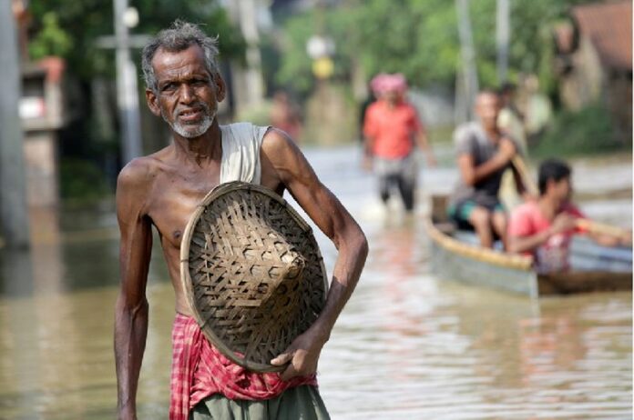 An Indian villager wades through a flooded street in Prafulla Nagar, some 120km north of Calcutta, India, 03 August 2015. More than 100 people have been killed, most of them in India's eastern states, during heavy rains and floods over the past week. EPA/PIYAL ADHIKARY