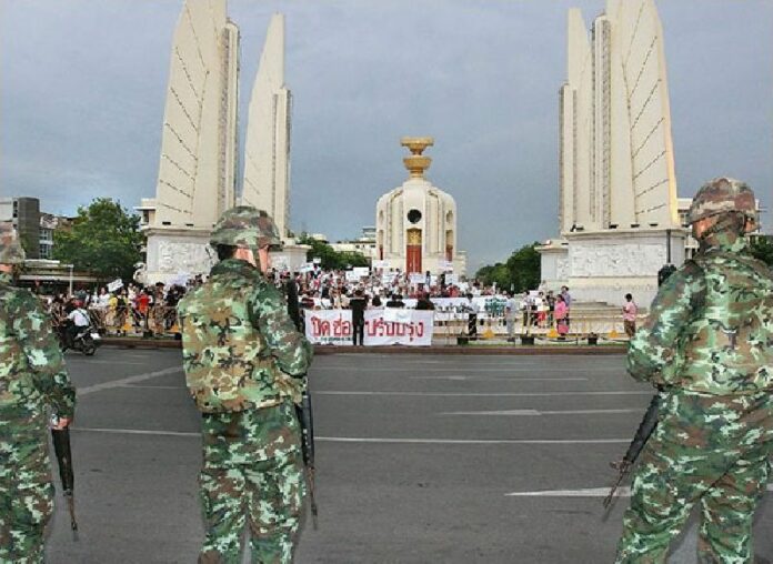 Soldiers watch over a pro-coup rally at Bangkok's Democracy Monument in this file photo from June 2014.