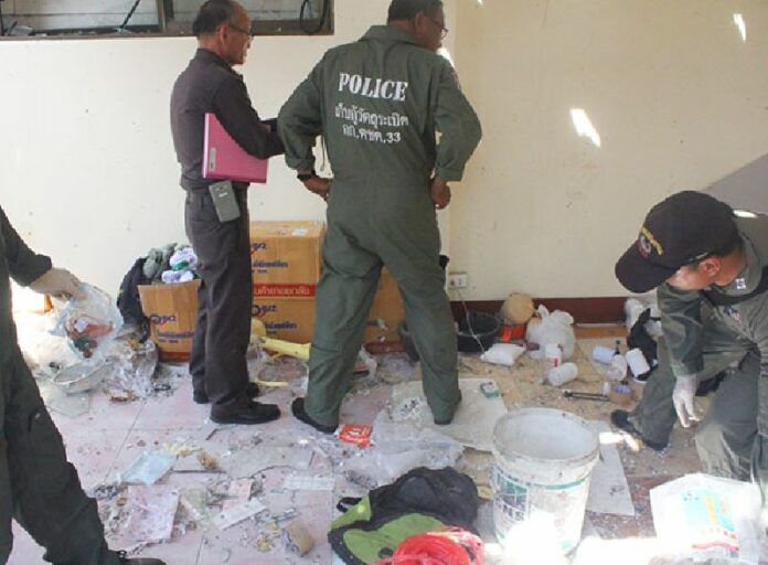 A police bomb unit inspect the scene where they said a Chiang Mai university student was seriously injured by an accidental blast in his home/bomb-making den.